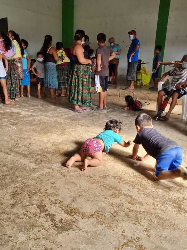 Two children playing on the floor of the clinic.